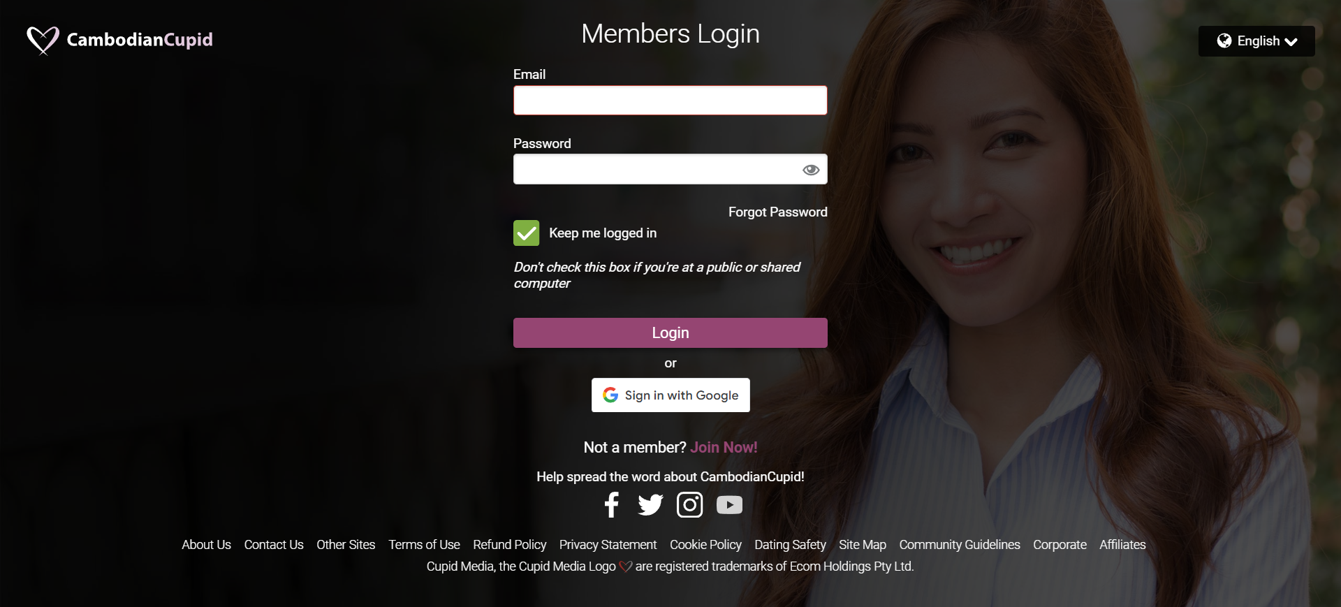 A woman smiles confidently while standing in front of a computer login page, exuding positivity and readiness.