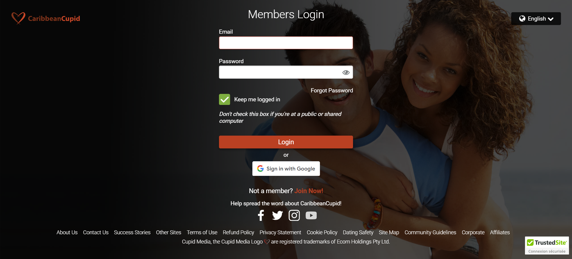 A happy couple smiles together in front of a computer screen displaying a login page.