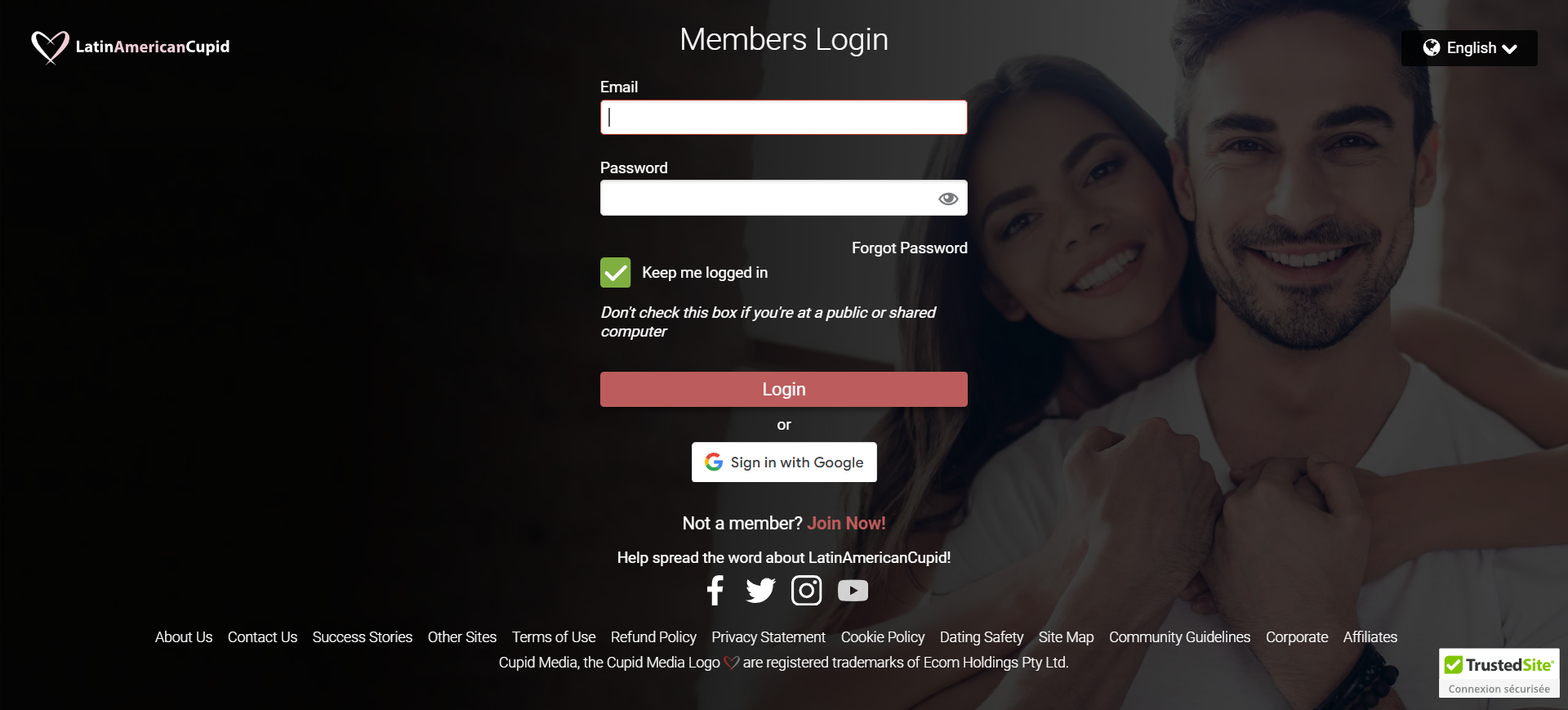 A happy couple smiles together in front of a computer screen displaying a login page.